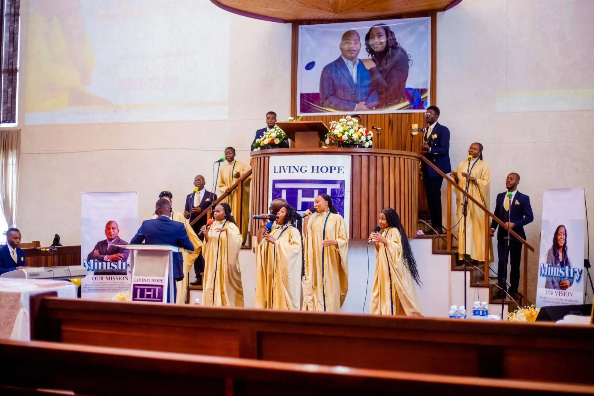 The choir in gold robes leading worship from the front of the sanctuary