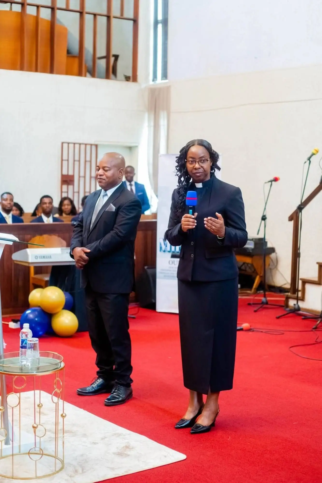 Bishop Collins Uta and Bishop Marjorie Uta at the front of the sanctuary
